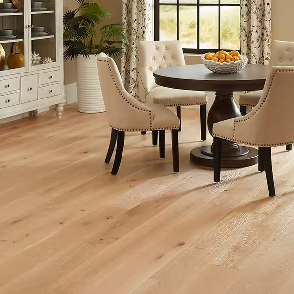 Dining room with pale, wire-brushed oak planks from Veranda's Charleston collection in Sea Oats (manufacturer room scene)