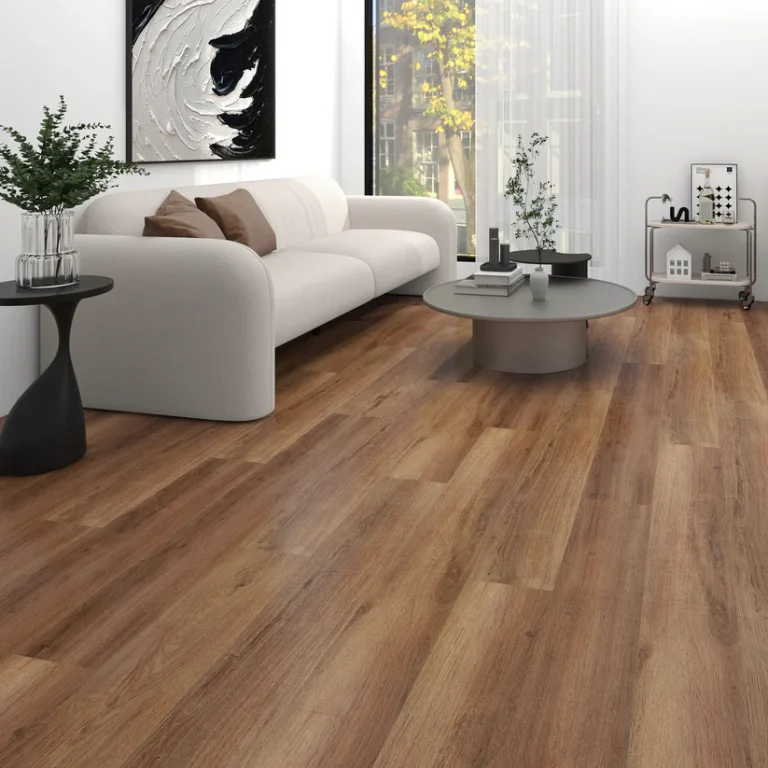 Living room with medium-brown wood-look Belocore SPC Canela vinyl plank flooring, a white sofa and a round gray coffee table